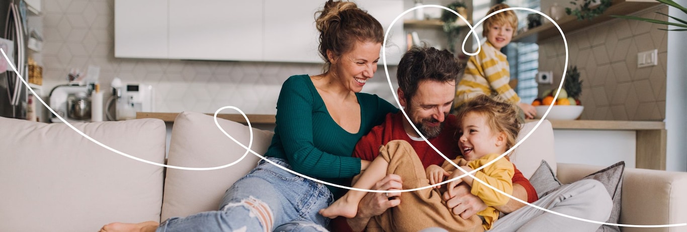 familie fericita pe canapea in living open space